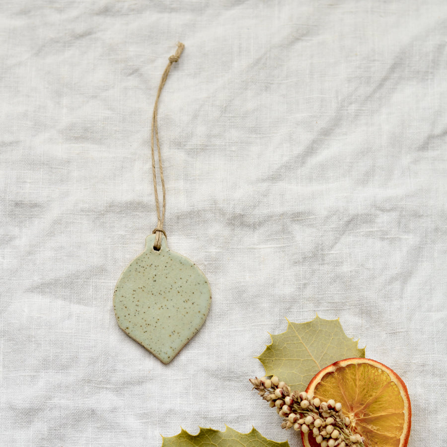 Handmade ceramic Christmas bauble ornament in soft speckled green colour by Kim Wallace Ceramics Australia