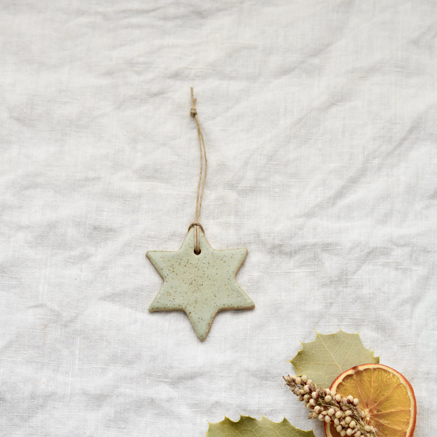 Handmade ceramic Christmas star  ornament in soft speckled green colour by Kim Wallace Ceramics Australia